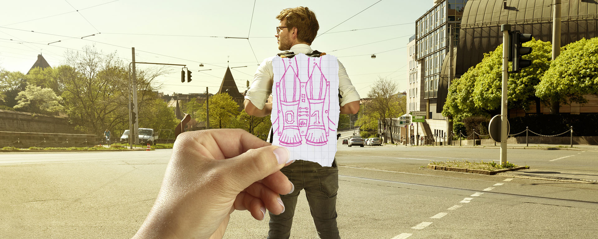 Man stands on the street, hand simulates a rocket backpack